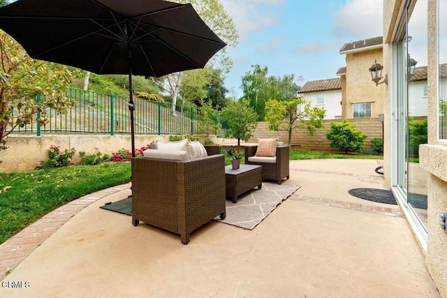 view of patio featuring an outdoor living space and a fenced backyard