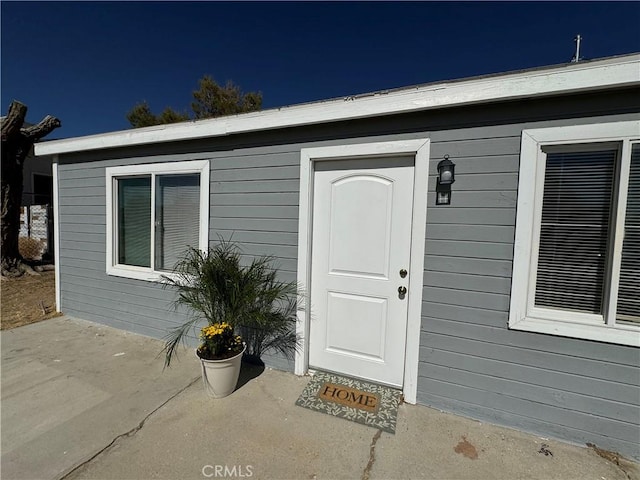entrance to property featuring a patio area