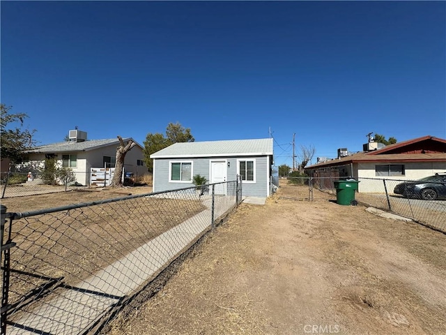 view of front of property with a fenced backyard and central AC unit