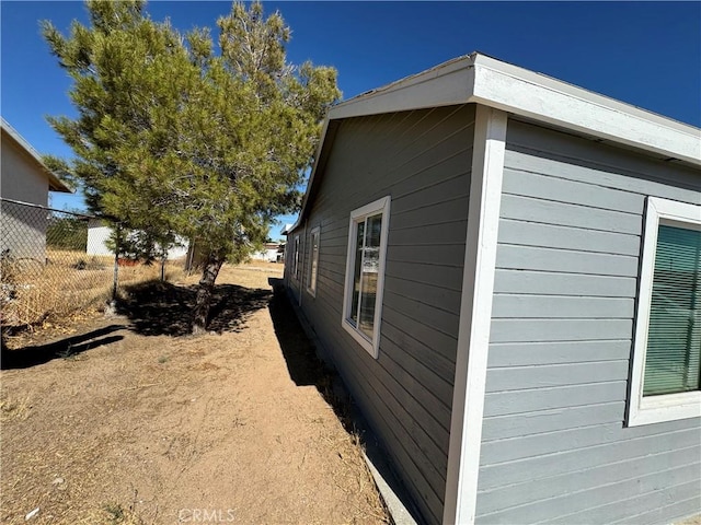 view of home's exterior featuring fence