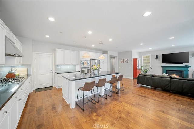 132 Carrotwood, Irvine, CA 92618 - kitchen featuring a kitchen breakfast bar, tasteful backsplash, open floor plan, a kitchen island, and appliances with stainless steel finishes