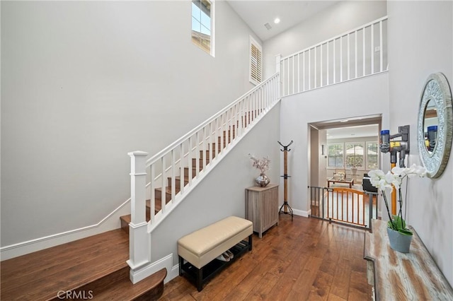 132 Carrotwood, Irvine, CA 92618 - staircase featuring hardwood / wood-style flooring, baseboards, a towering ceiling, and recessed lighting