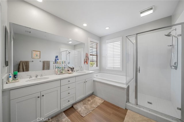 132 Carrotwood, Irvine, CA 92618 - bathroom featuring wood finished floors, visible vents, a sink, and a shower stall