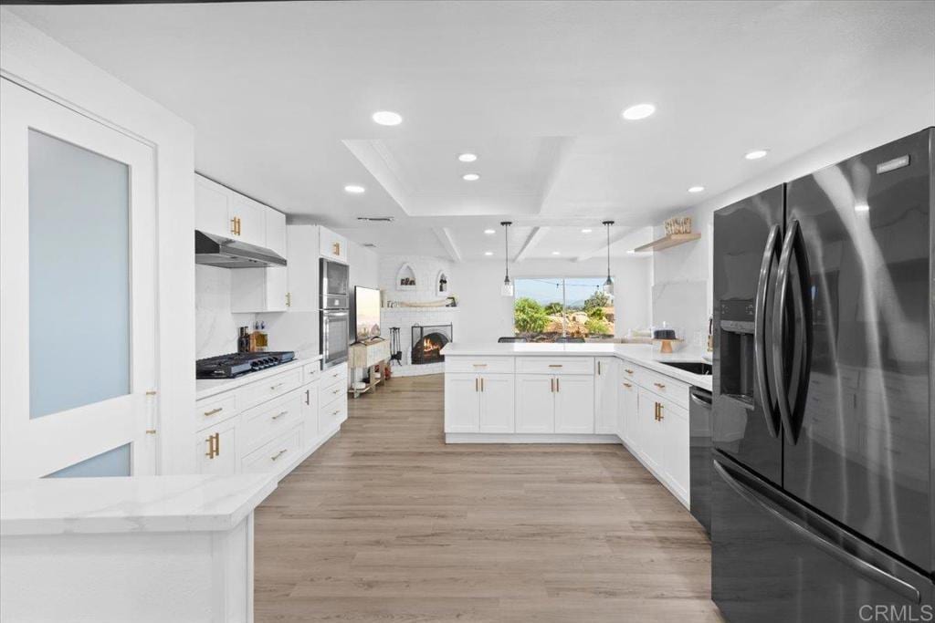 402 Ali Way, Fallbrook, CA 92028 - kitchen with black appliances, under cabinet range hood, a peninsula, recessed lighting, and white cabinetry