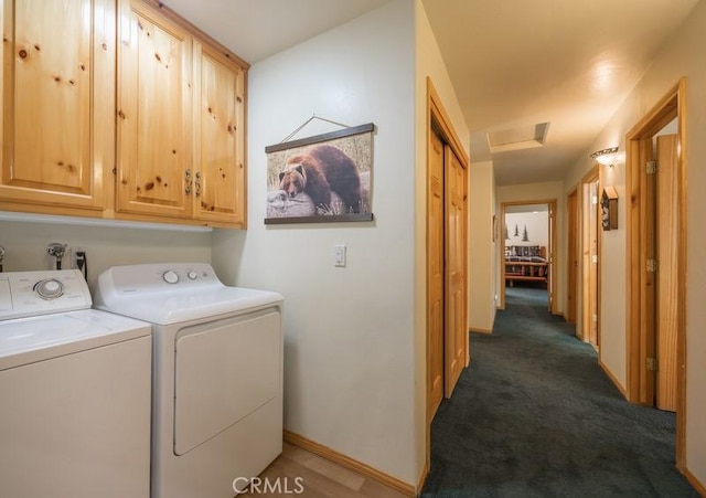 laundry room with washing machine and clothes dryer, attic access, baseboards, carpet, and cabinet space