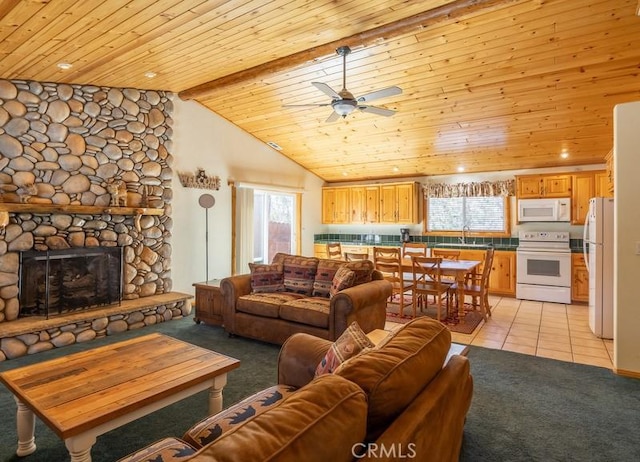 living area featuring light colored carpet, ceiling fan, wood ceiling, and a fireplace