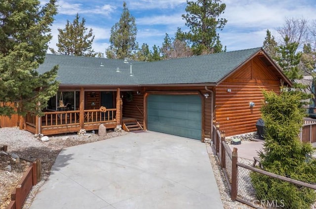 view of front facade featuring concrete driveway, an attached garage, fence, a porch, and roof with shingles