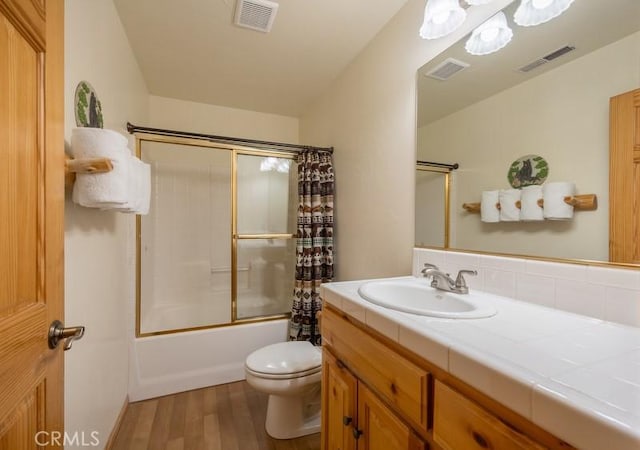 full bathroom with wood finished floors, visible vents, toilet, and vanity