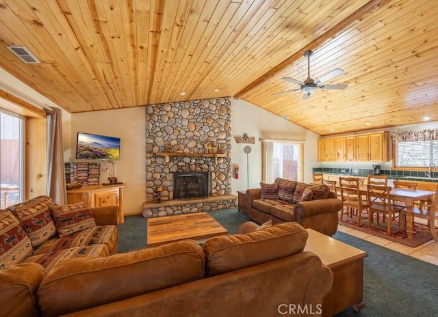 living area with visible vents, a ceiling fan, wooden ceiling, lofted ceiling with beams, and carpet flooring
