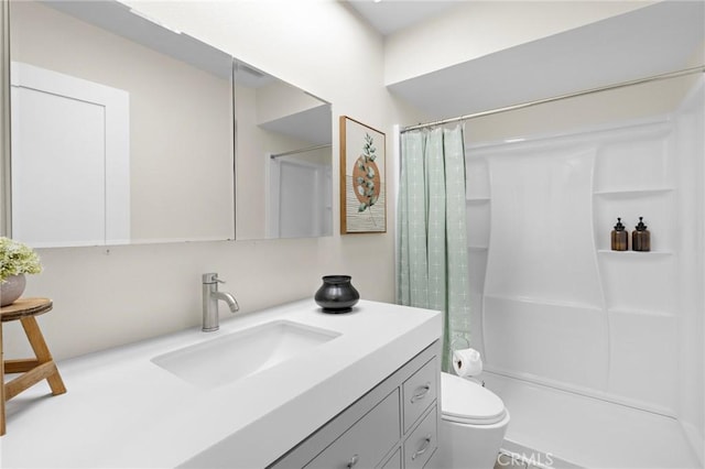 full bath with a shower stall, toilet, and vanity