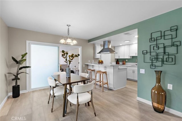 dining room featuring light wood-style floors, baseboards, a notable chandelier, visible vents, and recessed lighting
