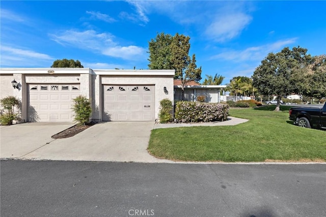 5367 Algarrobo Unit C, Laguna Woods, CA 92637 - view of front facade featuring concrete driveway, a front lawn, a garage, and stucco siding