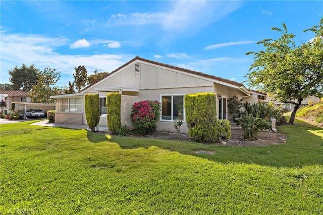 view of side of property with a yard and stucco siding