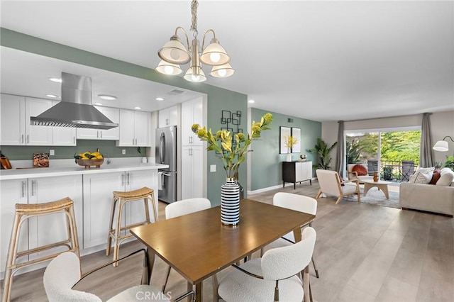 dining area featuring light wood-type flooring, visible vents, an inviting chandelier, and recessed lighting