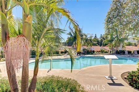 community pool with a patio area