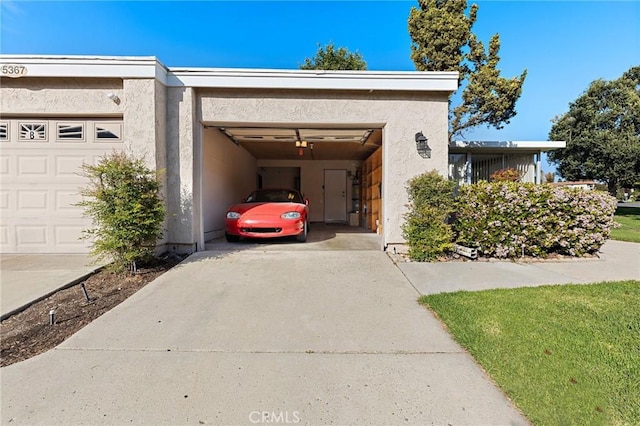 exterior space with stucco siding, driveway, and a garage