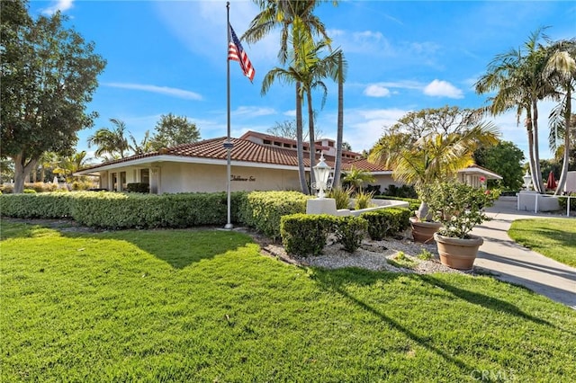 5367 Algarrobo Unit C, Laguna Woods, CA 92637 - view of property exterior featuring stucco siding, a lawn, and a tiled roof