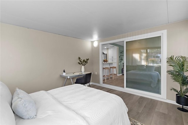 bedroom with wood finished floors and baseboards