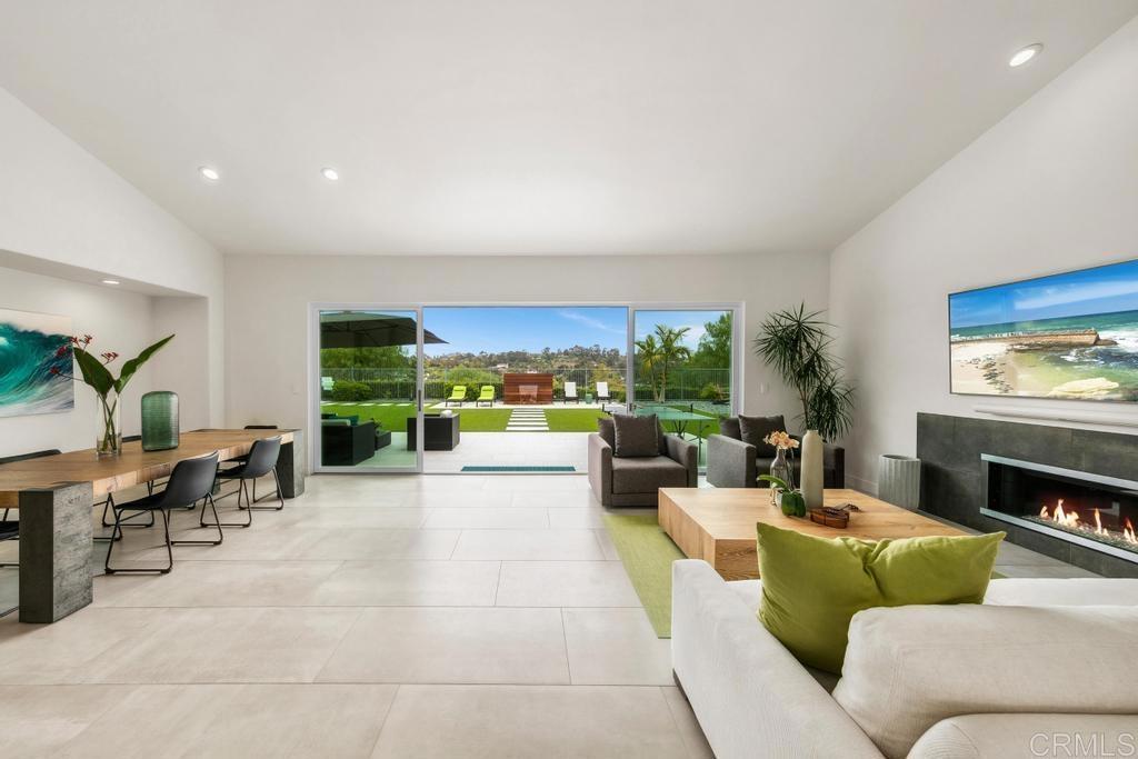 1504 Hamilton Ln, Escondido, CA 92029 - living room featuring recessed lighting, tile patterned flooring, a glass covered fireplace, and lofted ceiling