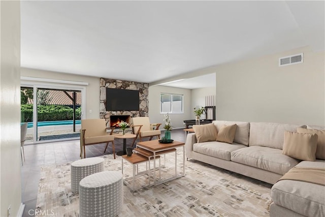 6304 Tamarind St, Oak Park, CA 91377 - living room featuring wood finished floors, visible vents, and a fireplace