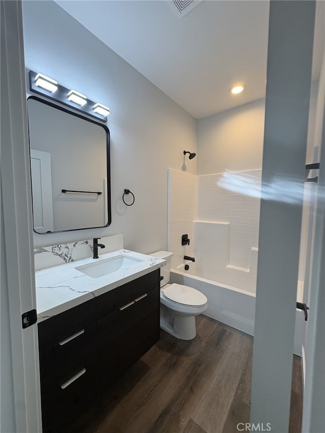 12525 Spring Valley Pkwy, Victorville, CA 92395 - bathroom featuring toilet, washtub / shower combination, vanity, and wood finished floors