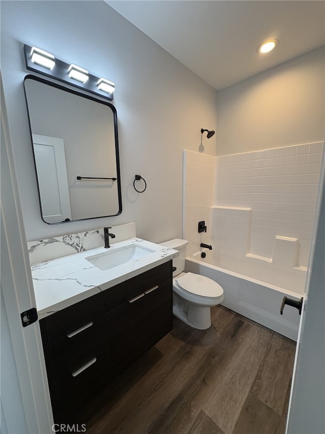 12525 Spring Valley Pkwy, Victorville, CA 92395 - full bath featuring toilet, vanity, wood finished floors, and tub / shower combination