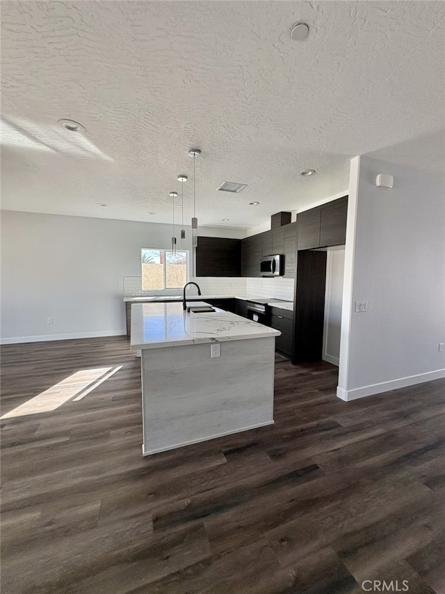 12525 Spring Valley Pkwy, Victorville, CA 92395 - kitchen with modern cabinets, stainless steel microwave, baseboards, and a textured ceiling