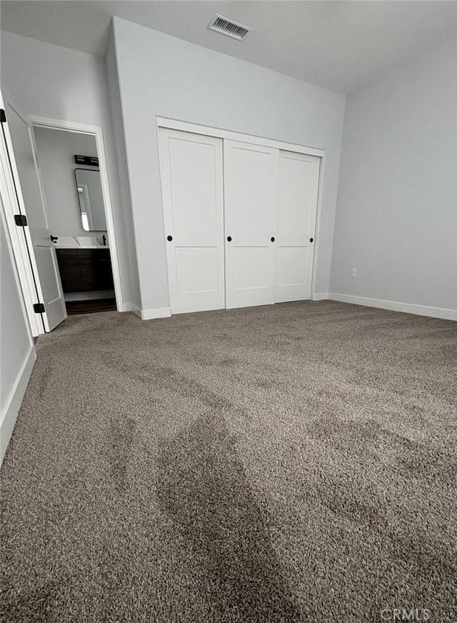 12525 Spring Valley Pkwy, Victorville, CA 92395 - unfurnished bedroom featuring baseboards, carpet floors, visible vents, and a closet