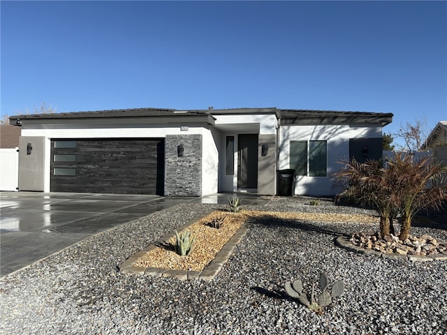12525 Spring Valley Pkwy, Victorville, CA 92395 - view of front facade with concrete driveway, stucco siding, and a garage