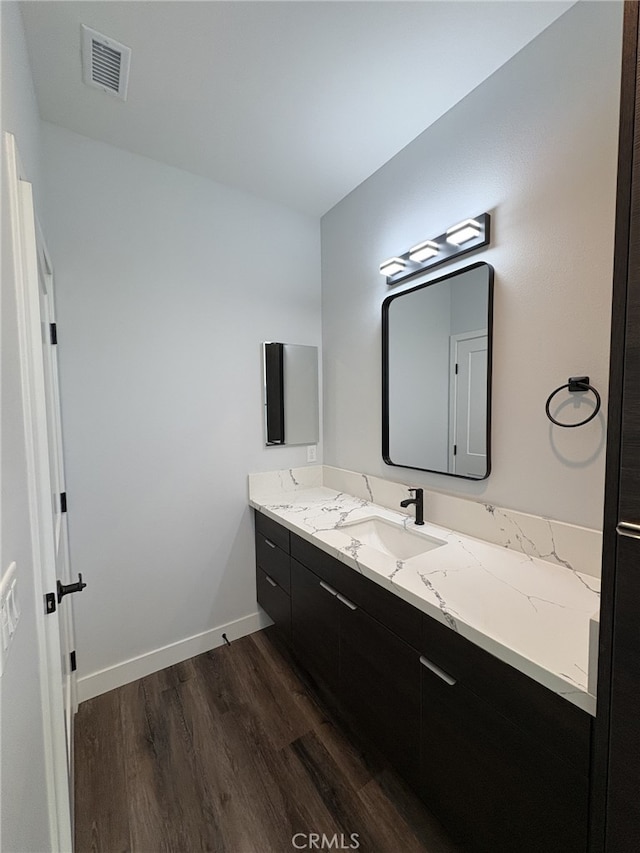 12525 Spring Valley Pkwy, Victorville, CA 92395 - bathroom with baseboards, vanity, wood finished floors, and visible vents