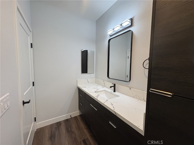 12525 Spring Valley Pkwy, Victorville, CA 92395 - bathroom with baseboards, wood finished floors, and vanity