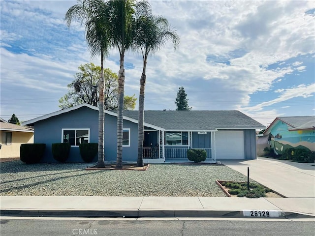 single story home featuring driveway, covered porch, and a garage