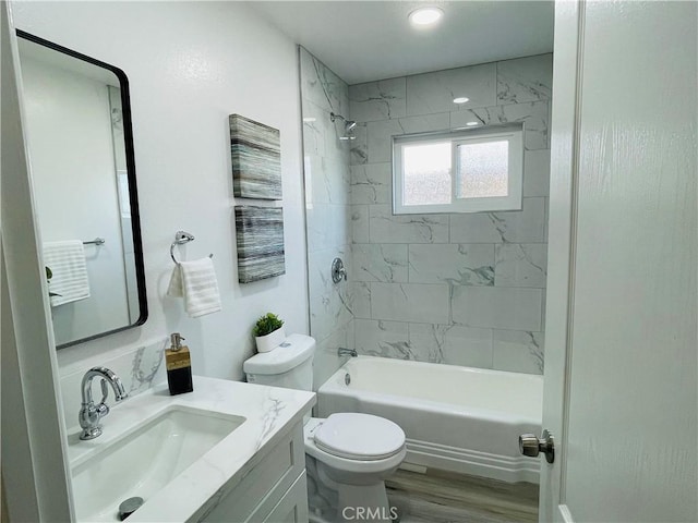 full bath with shower / washtub combination, toilet, vanity, and wood finished floors