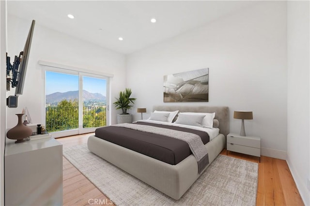 bedroom with recessed lighting, light wood finished floors, baseboards, and access to outside