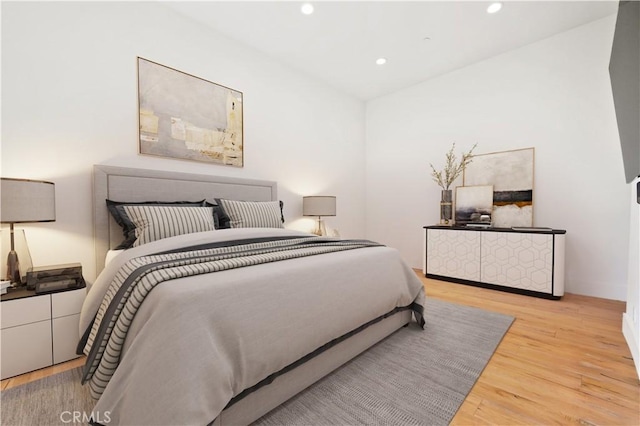 bedroom with recessed lighting and light wood-type flooring