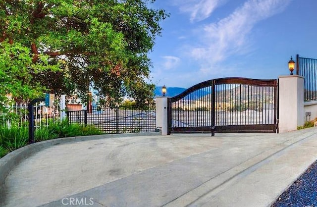 view of gate with fence