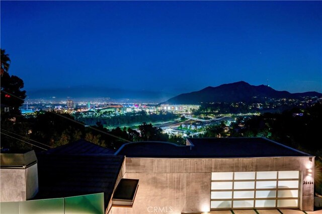 mountain view featuring a view of city lights