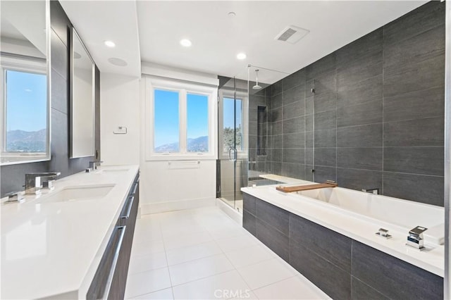 bathroom with a bath, tile patterned floors, a sink, a stall shower, and visible vents