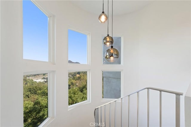 stairway featuring a wealth of natural light and a towering ceiling
