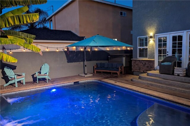 pool with an outdoor hangout area, french doors, and a patio area