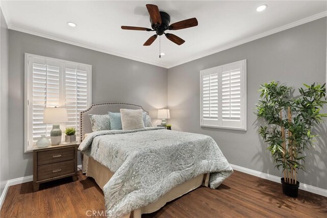 bedroom featuring baseboards, multiple windows, and dark wood-type flooring