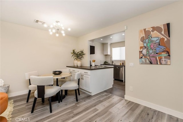 4164 Tujunga Ave Unit 102, Studio City, CA 91604 - dining area with light wood finished floors and a chandelier