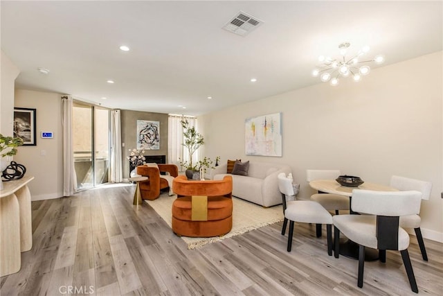 4164 Tujunga Ave Unit 102, Studio City, CA 91604 - living area with light wood-type flooring, recessed lighting, a chandelier, and a fireplace