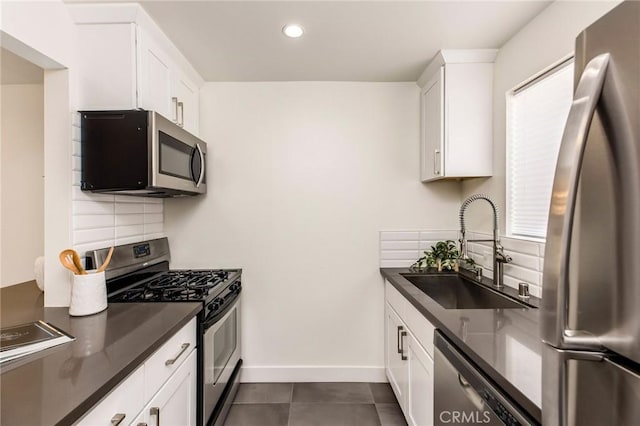 4164 Tujunga Ave Unit 102, Studio City, CA 91604 - kitchen with appliances with stainless steel finishes, dark countertops, decorative backsplash, white cabinets, and recessed lighting