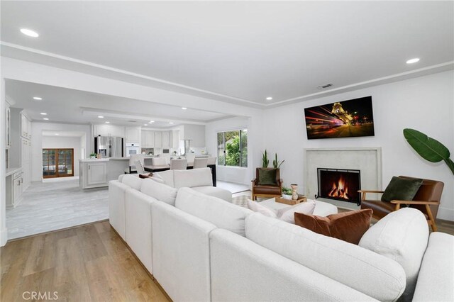 162 Acacia Ave, Monrovia, CA 91016 - living area featuring light wood-style floors, a fireplace, and recessed lighting
