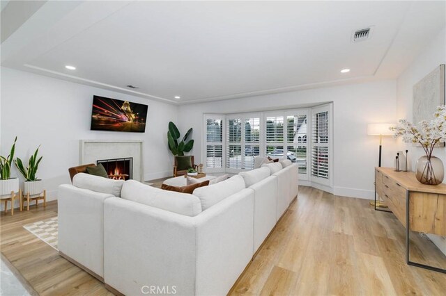 162 Acacia Ave, Monrovia, CA 91016 - living area featuring a warm lit fireplace, light wood finished floors, and recessed lighting