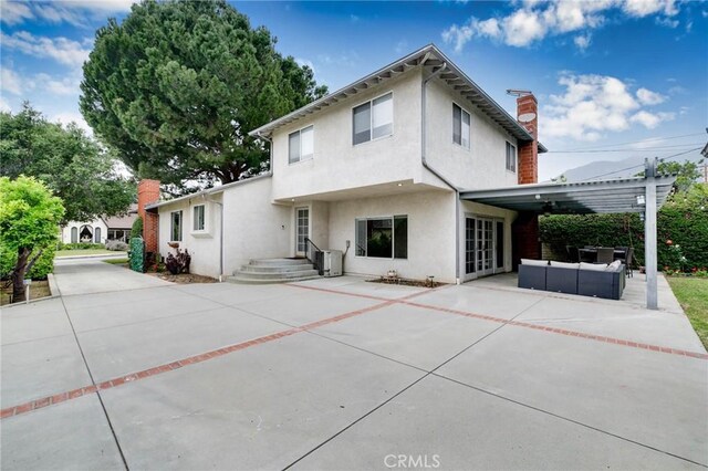 162 Acacia Ave, Monrovia, CA 91016 - rear view of property with a chimney, stucco siding, an outdoor living space, and a patio area