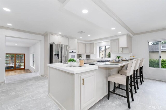 162 Acacia Ave, Monrovia, CA 91016 - kitchen featuring stainless steel fridge with ice dispenser, oven, plenty of natural light, light countertops, and ornamental molding