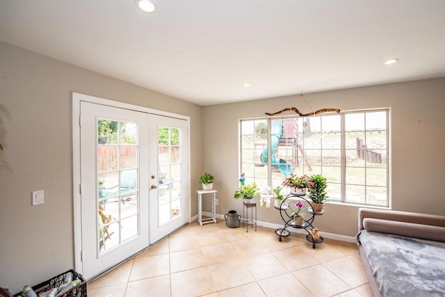 interior space with light tile patterned floors, recessed lighting, french doors, and baseboards