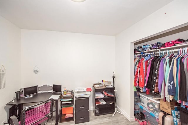 home office featuring baseboards and wood finished floors